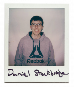 Daniel, man with glasses smiling at the camera